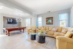 a living room with a couch and a pool table at Festival and Family Fun Permit# 50369 in Indio