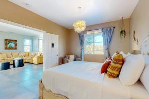 a bedroom with a white bed and a living room at Festival and Family Fun Permit# 50369 in Indio