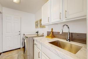 a white kitchen with a sink and a dishwasher at Festival and Family Fun Permit# 50369 in Indio +27 photos