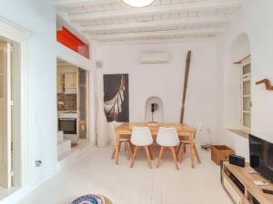 a kitchen and dining room with a table and chairs at The Sunday House in the heart of Mykonos Town in Mýkonos City