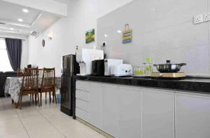 a kitchen with a counter top and a dining room at Casa Le Deer 鹿小居 in Kuah