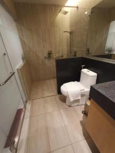 a bathroom with a white toilet and a shower at Domo Japanese Style Bedroom in Melaka