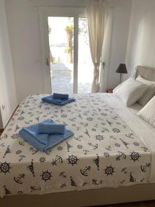 a bedroom with a bed with towels on it at The Captain's House in Skiathos Town