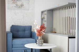 a vase with flowers on a table in a living room at Reset Boutique Hotel in Budva