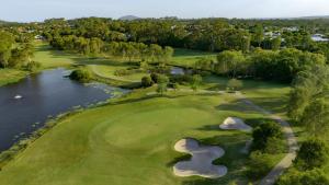 an overhead view of a golf course with a river at Luxury Golf Stay and Play in Peregian Springs