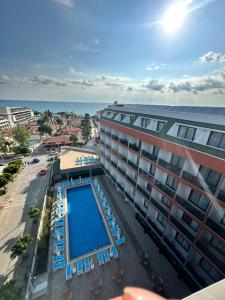 a view of a hotel with a swimming pool and the ocean at SiDE GOLDEN ROCK HOTEL&SPA in Side