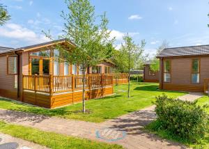 a home with a large deck and a house at Canterbury Reach Lodge Retreat in Petham