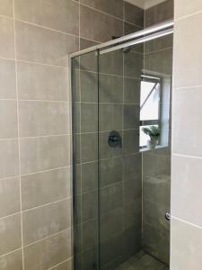 a shower with a glass door in a bathroom at The Blyde riverwalk estate in Pretoria