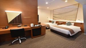 Odysis Suites Osaka Airport Hotel客房内的一张或多张床位