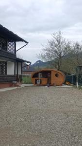 a building with a hobbit house in front of it at Casa Câmpulungeană in Câmpulung Moldovenesc