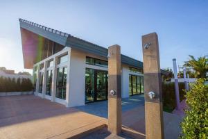 a large building with glass doors and windows at MOST Family 9 Ubon in Ubon Ratchathani
