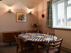 a dining room with a table and chairs and a window at Bosun Retreat in Burton
