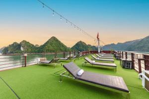 a deck of a cruise ship with lounge chairs at Blue Diamond Cruise in Ha Long