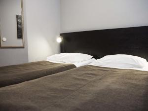 two beds sitting next to each other in a bedroom at Finlandia Park Hotel Helsinki in Helsinki