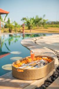 a table with a drink next to a swimming pool at Cabé Bali in Jasri