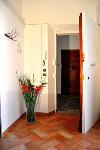 フィレンツェにあるキ モイ B & Bの赤花の花瓶が飾られた廊下