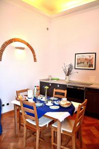 a dining room table with a blue table cloth on it at Chez Moi B&B in Florence