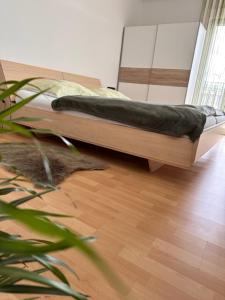 a bed sitting on top of a wooden floor at Ferienwohnungen Marek in Ravelsbach