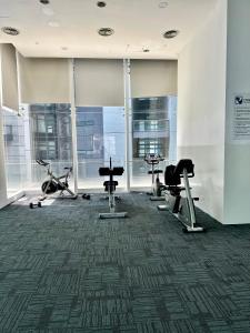 a gym with treadmills and exercise equipment in a building at Binjai 8 KLCC by PSM Luxury Suites in Kuala Lumpur
