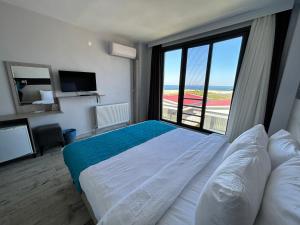 a hotel room with a bed and a large window at Yalıköy Deniz Otel Istanbul in Yalıköy