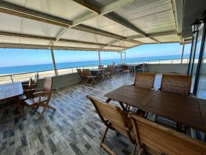 a restaurant with tables and chairs and the ocean at Yalıköy Deniz Otel Istanbul in Yalıköy