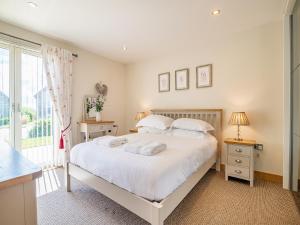 a bedroom with a bed and a large window at Twill Lodge - 4 Swandown in Cudworth