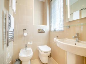 a bathroom with a toilet and a sink at Twill Lodge - 4 Swandown in Cudworth