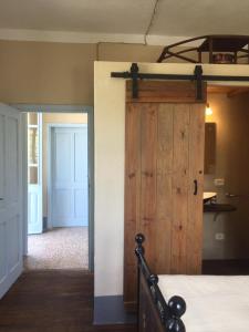 a bedroom with a wooden door and a bed in a room at Rosa'villa 9 in Murazzano