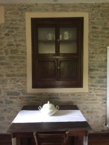 a tea pot sitting on a table in front of a cabinet at Rosa'villa 9 in Murazzano