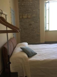 a bedroom with a bed with a pillow on it at Rosa'villa 9 in Murazzano
