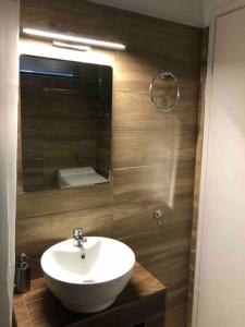 a bathroom with a white sink and a mirror at Studio στο Τολό in Tolo +30 photos