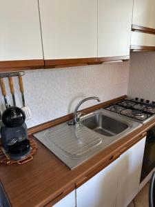 a kitchen with a sink and a stove at Luna in Fondachello