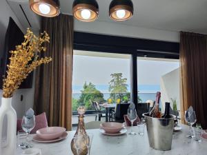 a dining room table with a view of the ocean at Golden Sunset 3 in Njivice