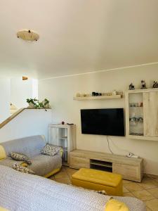 a living room with a flat screen tv and a couch at Villa Teresa in Ginosa Marina