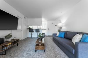 a living room with a couch and a tv at "INACTIVE UNBOOKABLE - 5 mins from Disneyland and Convention Center - Your Perfect SoCal Getaway!" in Anaheim