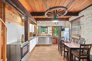 a large kitchen with a table and a ceiling at Blerick Country Retreat in Neerim South