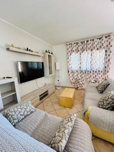 a living room with two beds and a flat screen tv at Villa Teresa in Ginosa Marina
