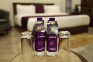 two bottles of purple liquid sitting on a table at Perfect Plus just 5 mins walk to Golden Temple in Amritsar