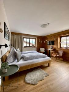 a bedroom with a large bed and a table at Haus Tirol Ehrwald in Ehrwald