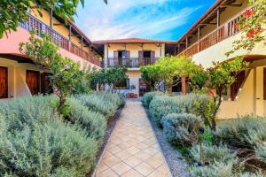 a courtyard of a house with lavender at Rigas Hotel Skopelos in Skopelos Town