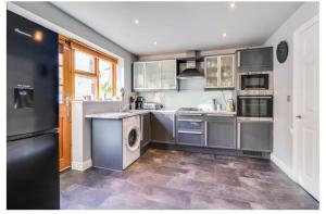 a kitchen with a washer and dryer at House of Kaima - 6 bed detached in Dewsbury