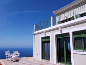 a house with a balcony with a view of the ocean at Porto Katsiki Blu in Athani