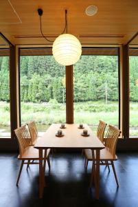 a table and chairs in a room with a large window at yabenomori 