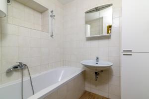 a bathroom with a bath tub and a sink at Apartment Premantura 2228a in Premantura +22 photos