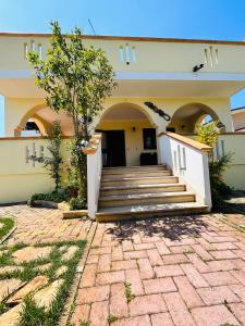 a building with a staircase in front of it at Villa Teresa in Ginosa Marina