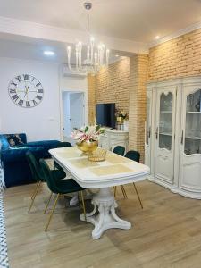 a living room with a white table and a blue couch at Marin Beach Apartment Malvarrosa in Valencia