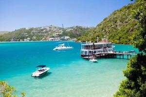 a boat is docked at a dock in the water at Forest Studio in Knysna