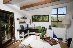 a kitchen with a table and a sink in a room at Forest Studio in Knysna