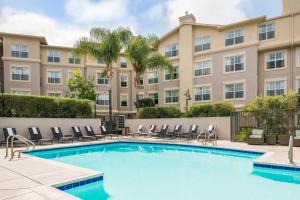 a swimming pool in front of a building at Residence Inn by Marriott Cypress Los Alamitos in Los Alamitos