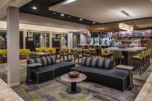 a restaurant with couches and tables and a bar at Courtyard Seattle Southcenter in Tukwila
